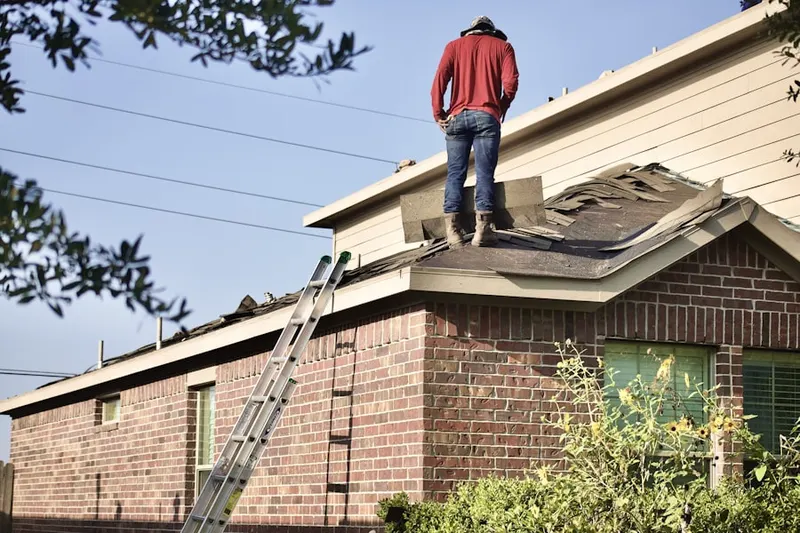 Professional roofer working on a residential roof in The Groves